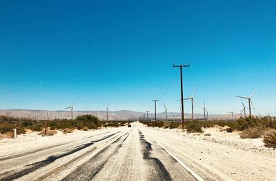 Road against clear blue sky