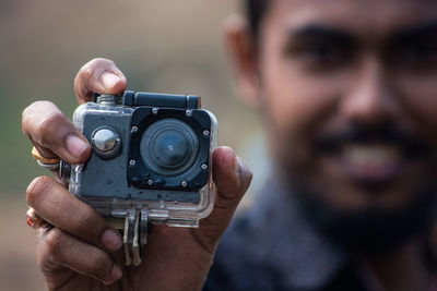 Close-up of man holding camera