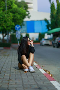 Woman with sitting on floor outdoors