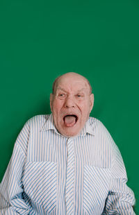 Portrait of man wearing mask against gray background