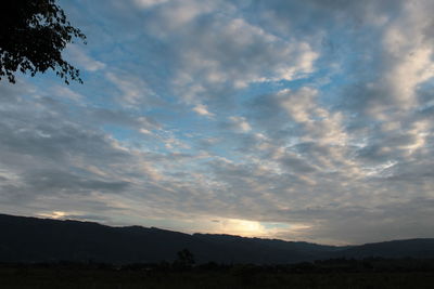 Scenic view of silhouette mountains against sky at sunset