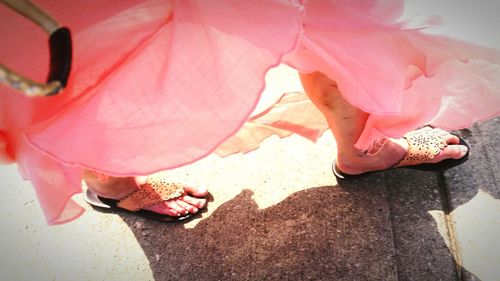 Low section of woman walking on footpath