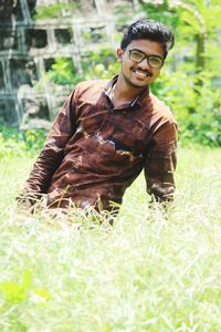 Portrait of young man standing on field