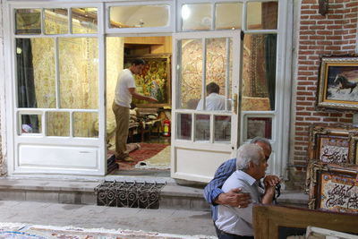 Man standing by window of building