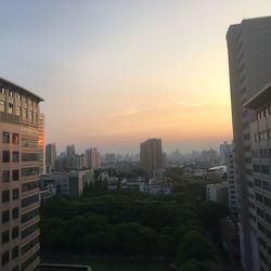 Buildings in city at sunset