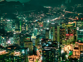 Illuminated cityscape against sky at night