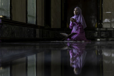 Woman standing on pink water