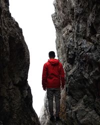 Rear view of man standing on rock formation