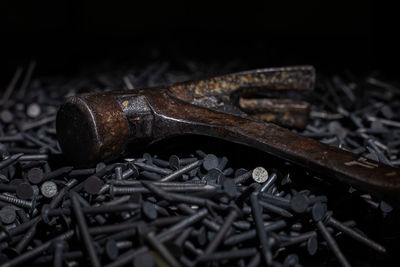 High angle view of rusty hammer over nails