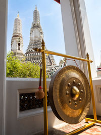 A dong bell,  mokugyo, with wat arun in bangkok, thailand in the background.