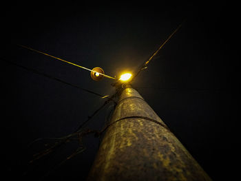 Low angle view of illuminated street light against sky at night