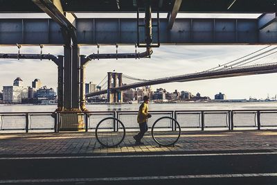 People walking on bridge in city