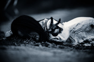 Portrait of woman lying down on land