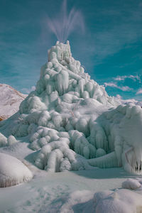 Scenic view of frozen lake against sky during winter