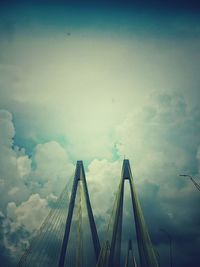 Low angle view of suspension bridge against sky