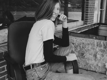 Smiling woman sitting on chair