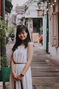 Beautiful young woman standing in front of building