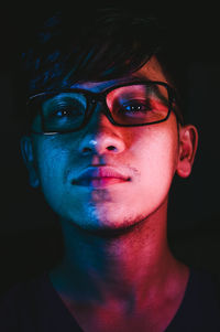 Portrait of mid adult man against black background