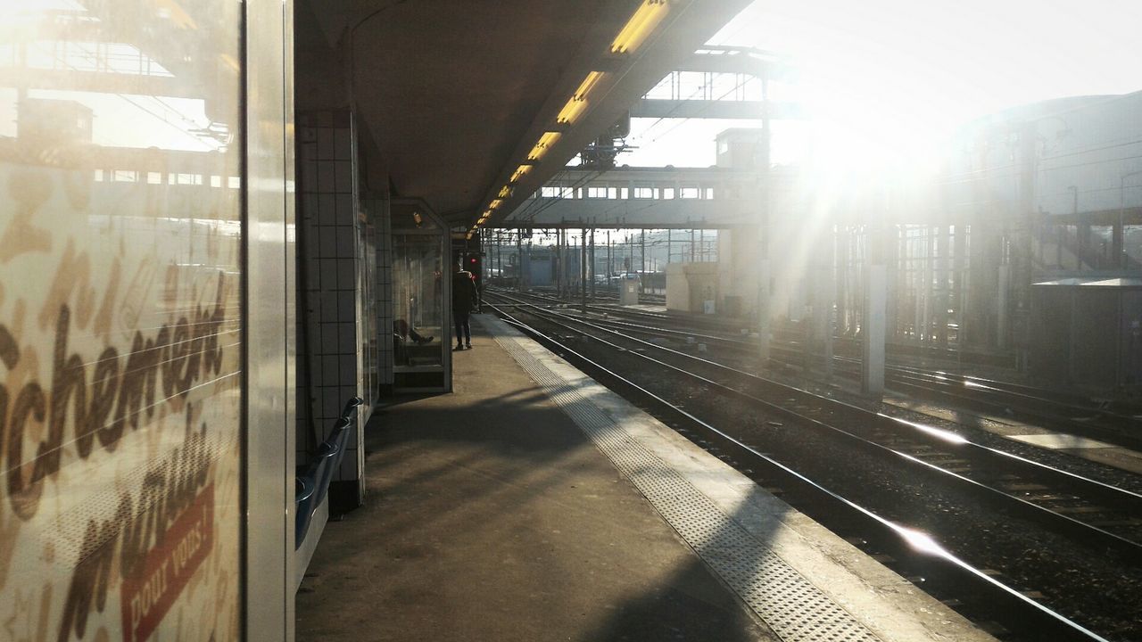 transportation, architecture, built structure, railroad track, public transportation, rail transportation, railroad station, the way forward, railroad station platform, indoors, building exterior, mode of transport, diminishing perspective, city, train - vehicle, sunlight, travel, vanishing point, public transport, passenger train