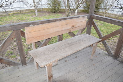 High angle view of wooden bench in park