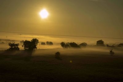 Scenic view of field against sky during sunset