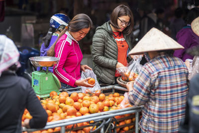 Group of people at market stall