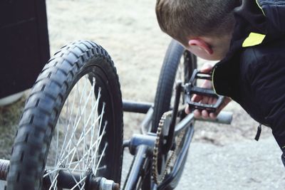 Boy with bicycle in city