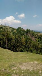 Scenic view of field against cloudy sky