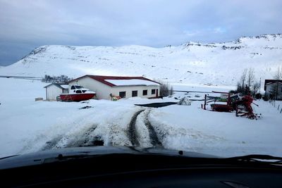 Snow covered road passing through mountain