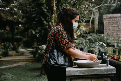 Side view of woman standing in water