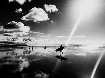 Silhouette of surferi against sky