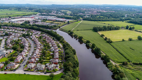 High angle view of townscape by river in city