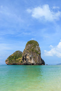 Rock formation in sea against sky