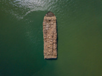 High angle view of a barge carrying timber. 