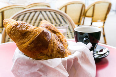 Close-up of croissants served on table at cafe