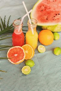 High angle view of juice with fruits on table