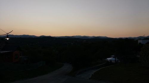 Scenic view of city against clear sky during sunset