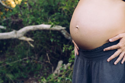 Midsection of woman touching head