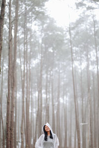 Portrait of woman standing in forest