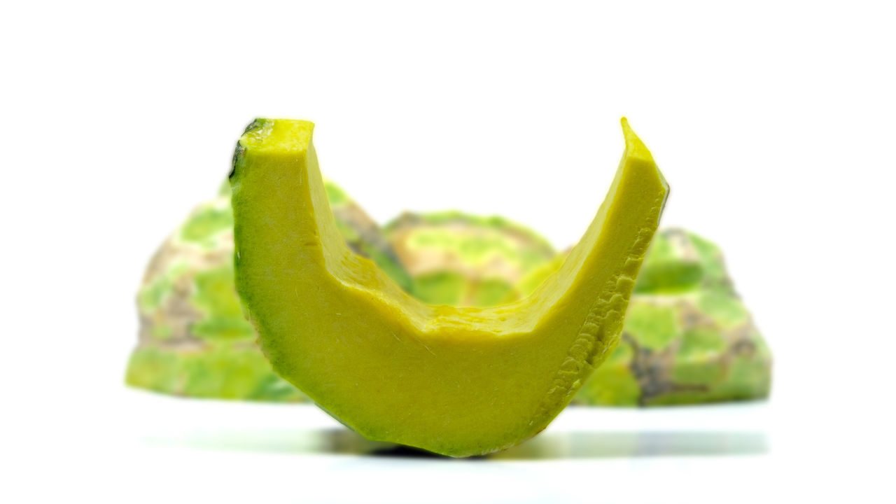 CLOSE-UP OF LEMON AGAINST WHITE BACKGROUND