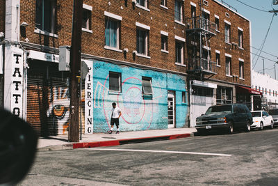 Road by building in city