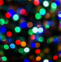 Defocused image of illuminated christmas lights at night