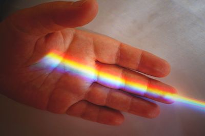 Close-up of person holding rainbow