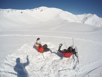 Rear view of people sliding on ski slope