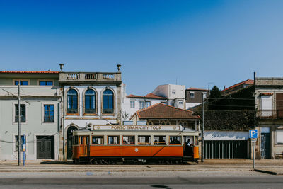 View of buildings in city against clear blue sky