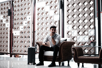 Portrait of young man sitting on chair