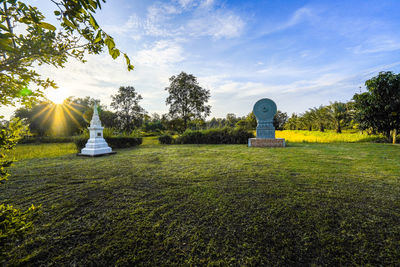 Stone sculpture on land against sky