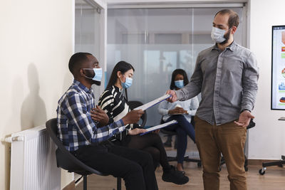 Business colleagues wearing mask working at office