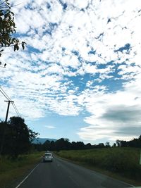 Cars on road against sky