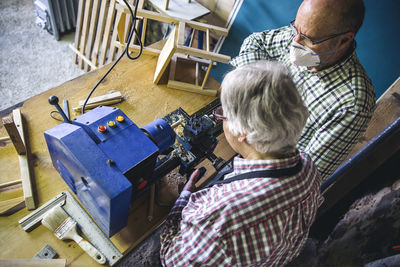 High angle view of carpenters working in workshop